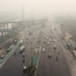 Traffic moves on a highway shrouded in smog in New Delhi