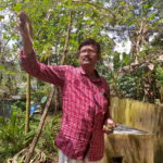 Sugathan P.R. collects vegetables in his kitchen garden in Pandalam village, Kerala