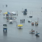 FILE PHOTO: People wade through a flooded beach after heavy rainfall in Chennai