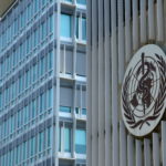 FILE PHOTO: A logo is pictured on the headquarters of the WHO in Geneva