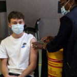A healthcare worker administers a dose of the Pfizer coronavirus disease (COVID-19) vaccine to a teenager, amidst the spread of the SARS-CoV-2 variant Omicron, in Johannesburg