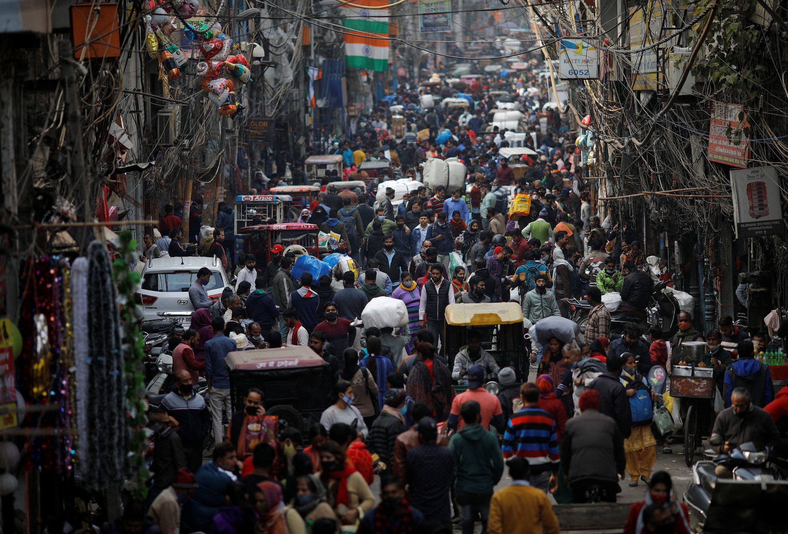 People shop at a crowded market amidst the spread of the coronavirus disease (COVID-19), in the old quarters of Delhi