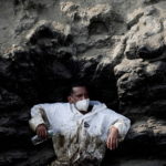 Workers clean up an oil spill in Ventanilla