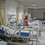 Staff member cleans medical equipment inside ward set up for Omicron coronavirus variant infected people at the Civil Hospital in Ahmedabad