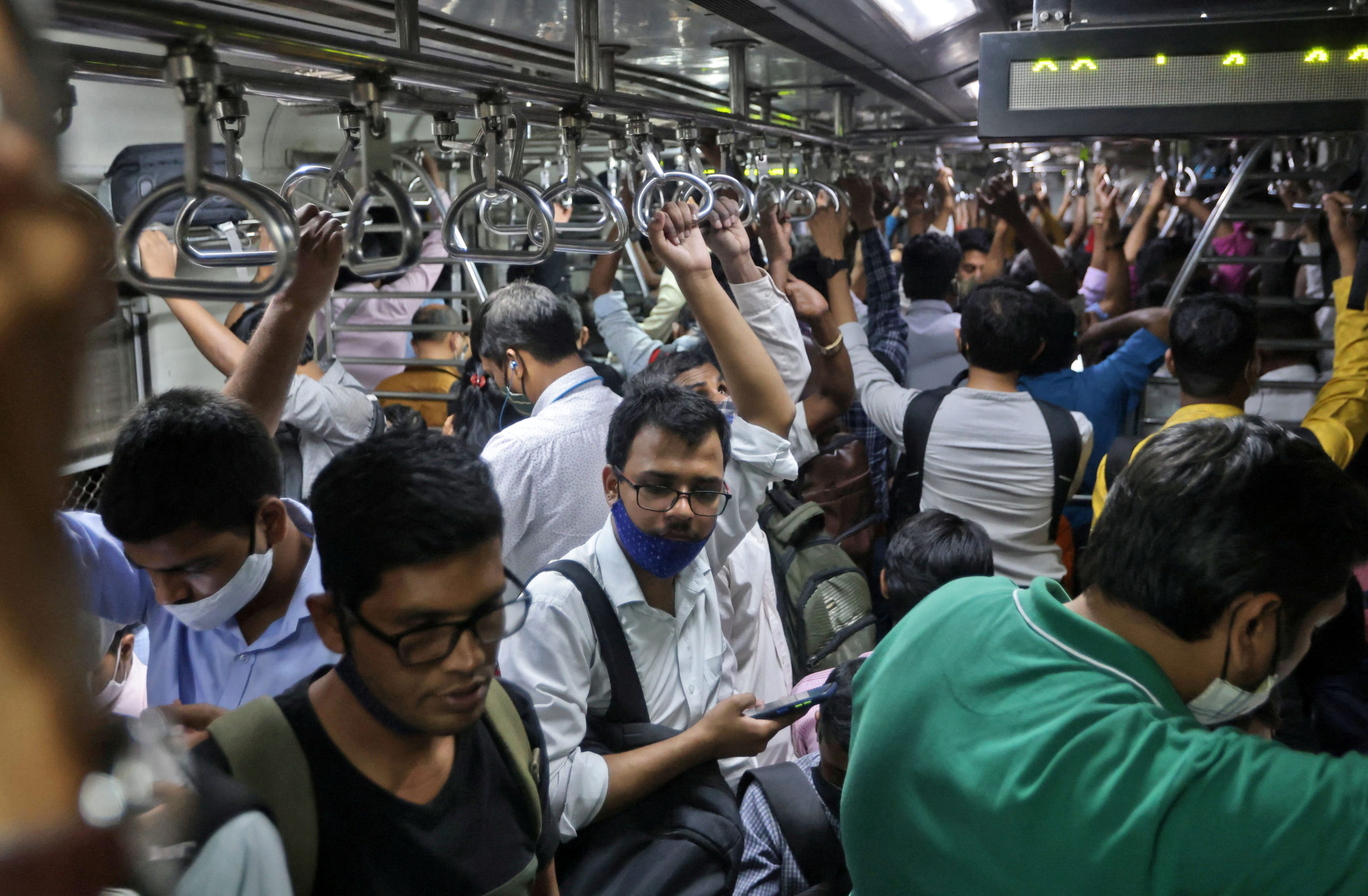 Commuters travel in a packed train in Mumbai