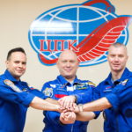 Crew members attend a news conference ahead of the expedition to the International Space Station at the Baikonur Cosmodrome
