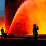 Rescuers work at a site of fuel storage facilities hit by cruise missiles in Lviv