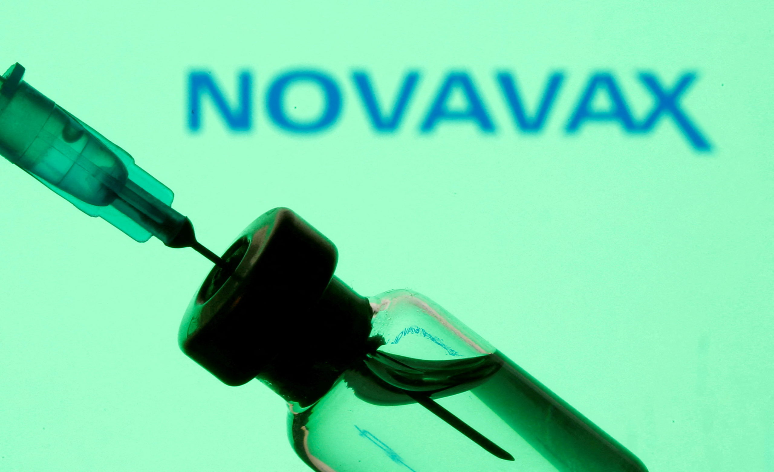 FILE PHOTO: FILE PHOTO: FILE PHOTO: Vial and sryinge are seen in front of displayed Novavax logo in this illustration