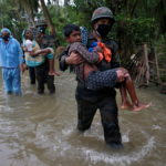 FILE PHOTO: Army soldiers evacuate people from a flooded area to safer places as Cyclone Yaas makes landfall at Ramnagar