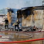 Firefighters extinguish a fire following recent shelling at a market in Donetsk
