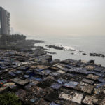 A view of a slum is seen along a seashore in Mumbai