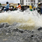 FILE PHOTO: Traffic moves as water is pumped out of an inundated residential area following torrential rains in Bengaluru