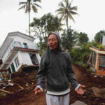 Badri stands near badly damaged houses after Monday's earthquake hit Cianjur