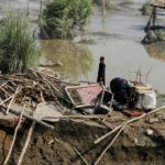 FILE PHOTO: A flood victim stands in his damaged house following rains and floods during the monsoon season, in Nowshera